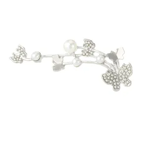 Elegant silver butterfly brooch with pearls and rhinestones on a winding metal curve