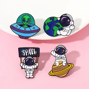 Set of four creative space enamel pins featuring astronauts, earth, and UFO on backpacks