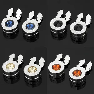 Detailed macro view of four round faceted crystal buttons in blue, black, amber, and champagne