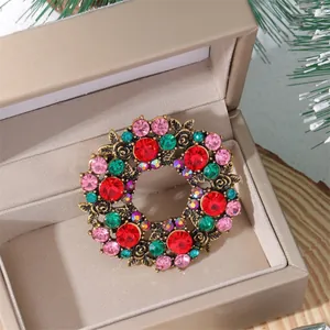 Close-up of a floral wreath brooch with colorful rhinestones in a festive gift box