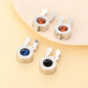 Detail of luxury magnetic lapel pins with colorful faceted gems and silver finish