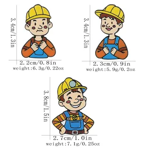 Three cartoon construction worker enamel pins with yellow hard hats and blue overalls