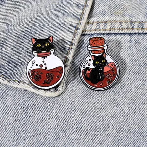 Detailed view of black cat enamel pins with potion bottles and red roses on denim fabric