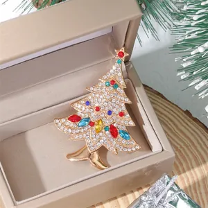 Detailed close-up of a sparkling crystal Christmas tree brooch in a premium jewelry box