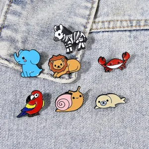 Set of 7 cute cartoon animal enamel pins featuring zebra lion and elephant on denim fabric