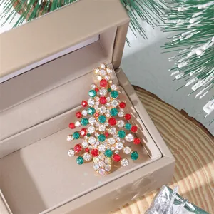 Close-up of a sparkling Christmas tree brooch with colorful rhinestones in a gift box