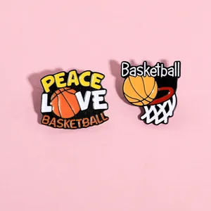 Detail of two enamel basketball pins featuring hoop and Peace Love Basketball text