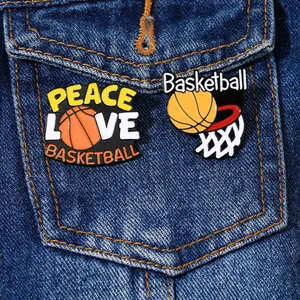 Detail of basketball enamel pins on denim fabric featuring Peace Love Basketball and net motifs