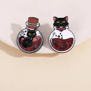 Detail of gothic black cat potion enamel pins with red liquid and rose on white tray