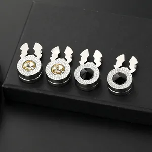 Detailed view of silver metal buttons with round champagne and black rhinestones