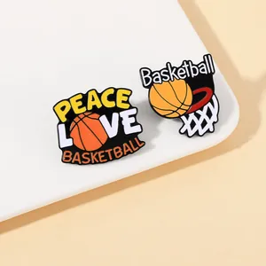 Detailed close-up of two enamel basketball pins showing Peace Love Basketball and a hoop