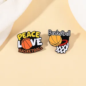 Detailed macro view of two basketball enamel pins with Peace Love Basketball lettering