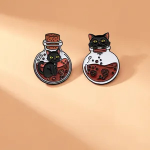 Detailed view of two black cat enamel pins featuring red potion bottles and roses
