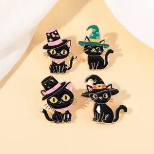 Close-up of four cute black cat enamel pins with colorful wizard hats and golden metal edges