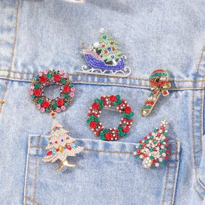 Chic Christmas rhinestone brooches featuring Xmas trees and wreaths on denim jacket