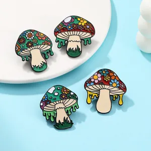 Set of four colorful mushroom enamel pins with floral patterns on polished white ceramic