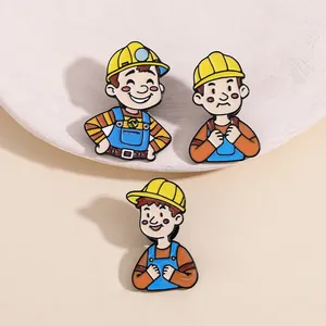 Detailed view of three cartoon engineer enamel pins featuring diverse facial expressions