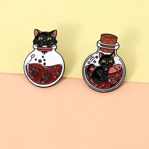 Detail of enamel pins featuring black cats with potion bottles and red roses
