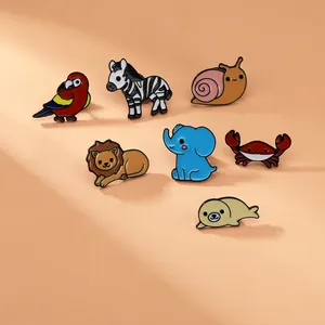 Detailed view of colorful cartoon animal enamel pins set on a warm orange background