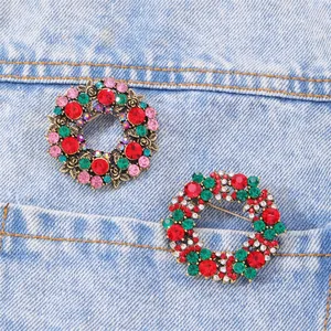 Detail of colorful crystal wreath brooches pinned on light blue denim fabric texture