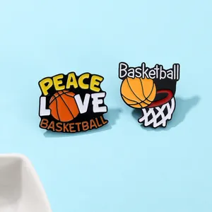 Macro shot of two basketball enamel pins featuring Peace Love Basketball and a net hoop