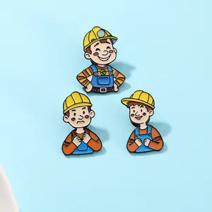 Detailed macro view of three cute cartoon miner enamel pins with yellow safety helmets