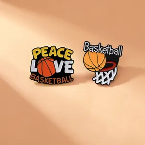 Macro shot of peace love basketball enamel pins with high saturation on orange background