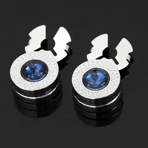 Macro shot of luxury navy blue crystal cufflinks with intricate silver textured border