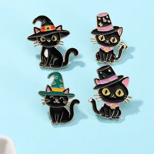 Detail of four enamel black cat pins with colorful wizard hats on a blue background