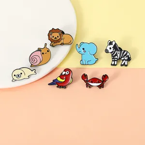 Detailed close-up of cute cartoon animal enamel pins including lion and elephant