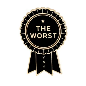 Funny medal shaped enamel brooch pin with black finish and The Worst text on white background