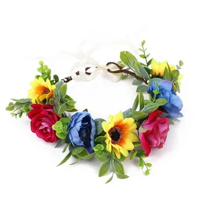 Bohemian floral crown with red roses and sunflowers on a vine base with white ribbon