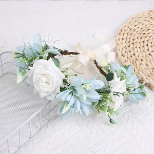 Floral crown with white roses and blue flowers on brown vine for bridal hair