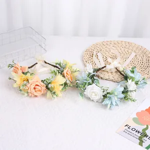 Detail view of realistic champagne and white floral crowns with adjustable ribbon ties