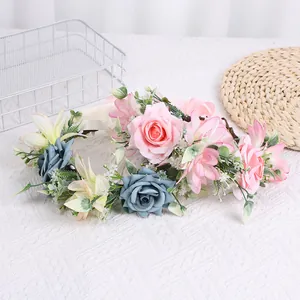 Detail of pink and blue rose floral headpiece with ribbon on white textured fabric