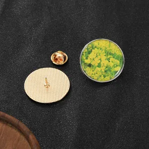 Detailed macro view of the vintage rape flower brooch with golden mesh back and butterfly clasp