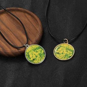 Macro shot of vintage resin rape flower pendants in gold and silver metal frames
