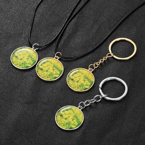 Detail of rapeseed flower resin pendants on necklaces and gold or silver keychains