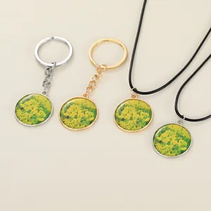 Close-up of vintage rapeseed flower pendants on necklaces and gold-tone keychains