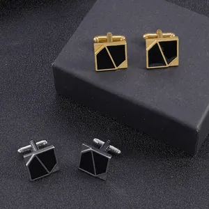 Detail shot of vintage geometric cufflinks in gold and silver set on a gift box