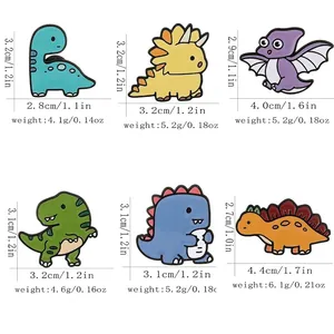 Size chart showing six cartoon dinosaur enamel pins with detailed dimensions and weights