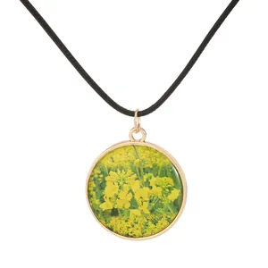 Vintage rapeseed flower pendant necklace with golden metal frame and black woven cord