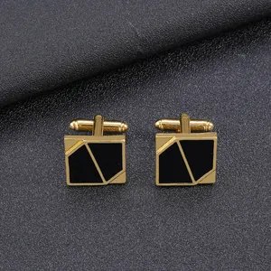 Detail of square gold cufflinks with black enamel inlay and geometric diagonal stripes