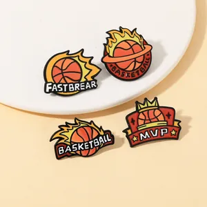 Dettaglio macro di quattro spillette creative in smalto da basket con motivi MVP