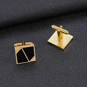 Elegant gold-plated square cufflinks with geometric black enamel inlay on grey leather background