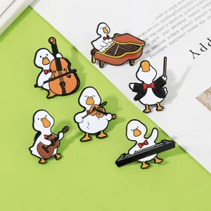 Close-up of enamel duck badges playing various musical instruments on a colored background