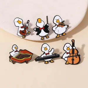 Detailed view of six cartoon duck enamel pins playing musical instruments on a beige background