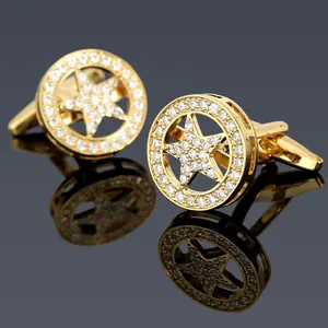 Macro detail of gold-plated star cufflinks with shimmering white micro-inlaid stones