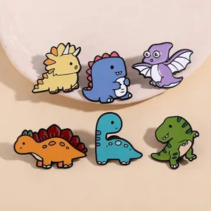 Close-up of colorful enamel dinosaur lapel pins featuring T-Rex and Triceratops shapes