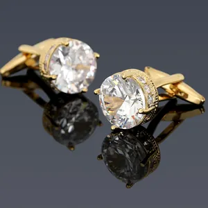 Macro shot of gold-plated round cufflinks with sparkling zircons and bullet back closure